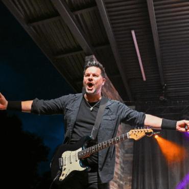 singer with arms outstretched