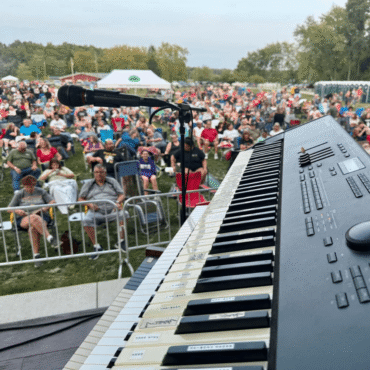 sharp angle keyboard with audience in background